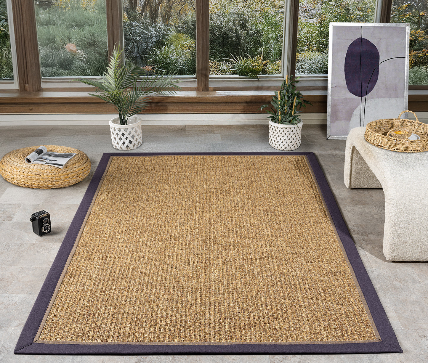 HALI VAGONU Mor Kahve Çift Renk Kumaş Bordürlü Sisal Halı, modern bir oturma alanında serili şekilde görünüyor. Bu el yapımı halı, kaliteli sisal dokusu ve şık desenleri ile hem bej sisal halı hem de krem sisal halı arayanlar için ideal bir seçim. Dekoratif sisal halı özellikleri ile dikkat çekiyor.